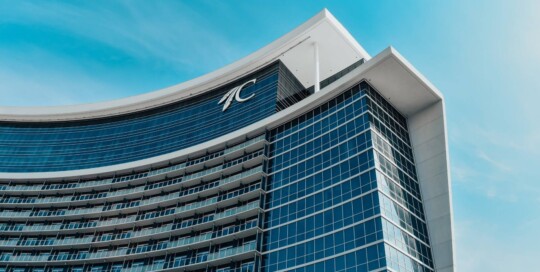 Choctaw Casino & Resort hotel exterior. Modern hotel tower set against blue Oklahoma sky.