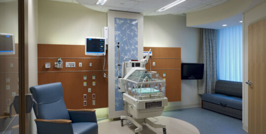 Hospital NICU suite with circular cream flooring surrounded by a blue perimeter. This image is meant to demonstrate expertise in healthcare flooring.